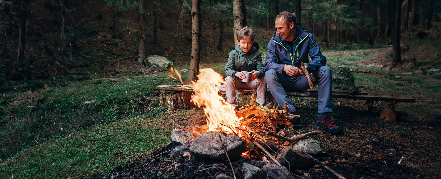 Firehawk design outdoor fire dad and son camping in the forest